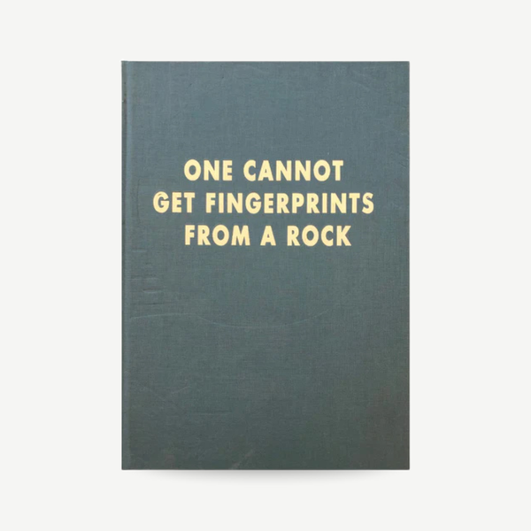Book with text 'ONE CANNOT GET FINGERPRINTS FROM A ROCK' on a white background Barry Reigate - One Cannot Get Fingerprints From A Rock