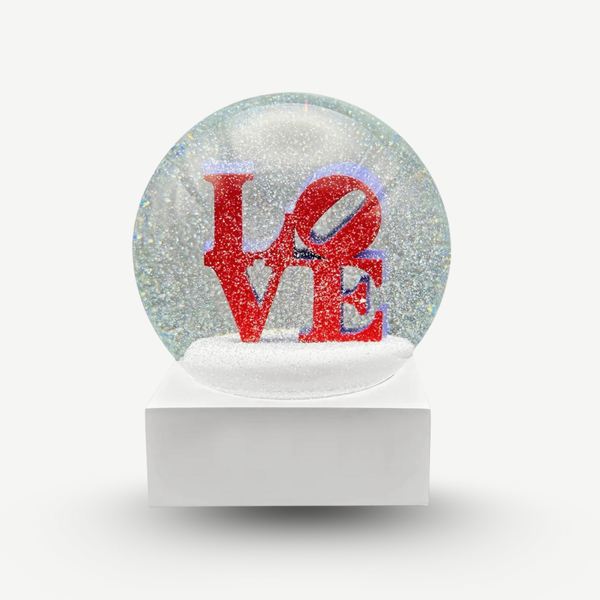 Snow globe with 'LOVE' text in red on a white background. Love by Robert Indiana official sculpture certified by the Morgan Art Foundation. Robert Indiana Collectible.
