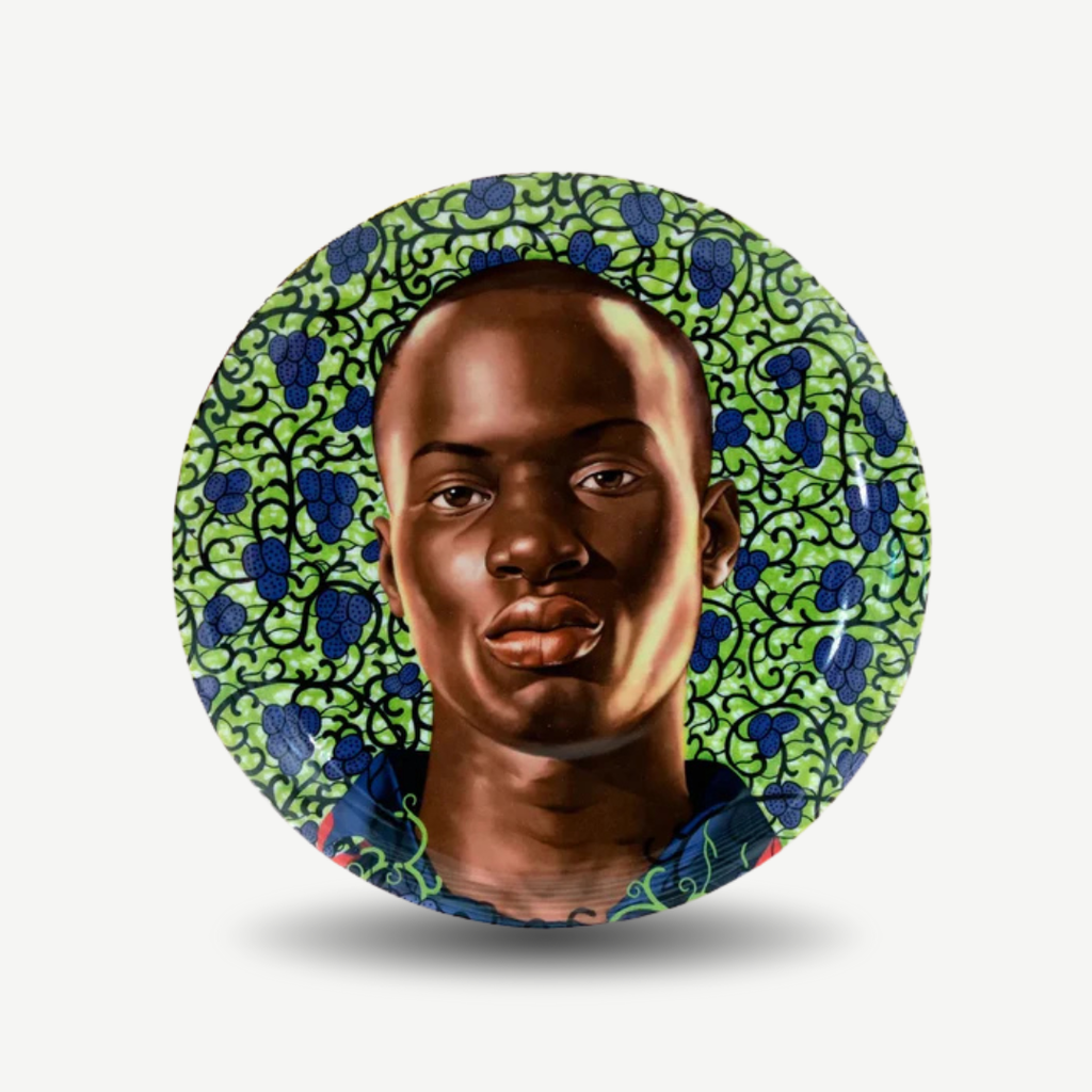 Circular artwork with a person's face framed by green and blue patterned border on a white background. Kehinde Wiley - Matar Mbaye II Plate