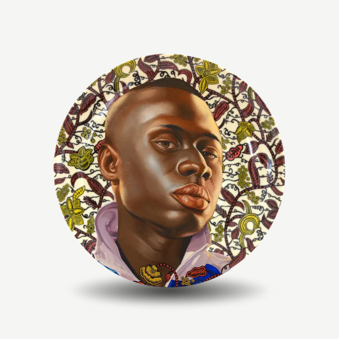 Decorative plate with a stylized portrait of a person surrounded by intricate patterns on a white background. Kehinde Wiley - Idrissa Plate