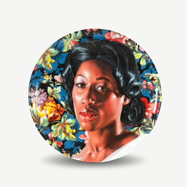 Decorative plate with a portrait of a woman surrounded by floral designs on a white background. Kehinde Wiley - Mrs. Graham Plate