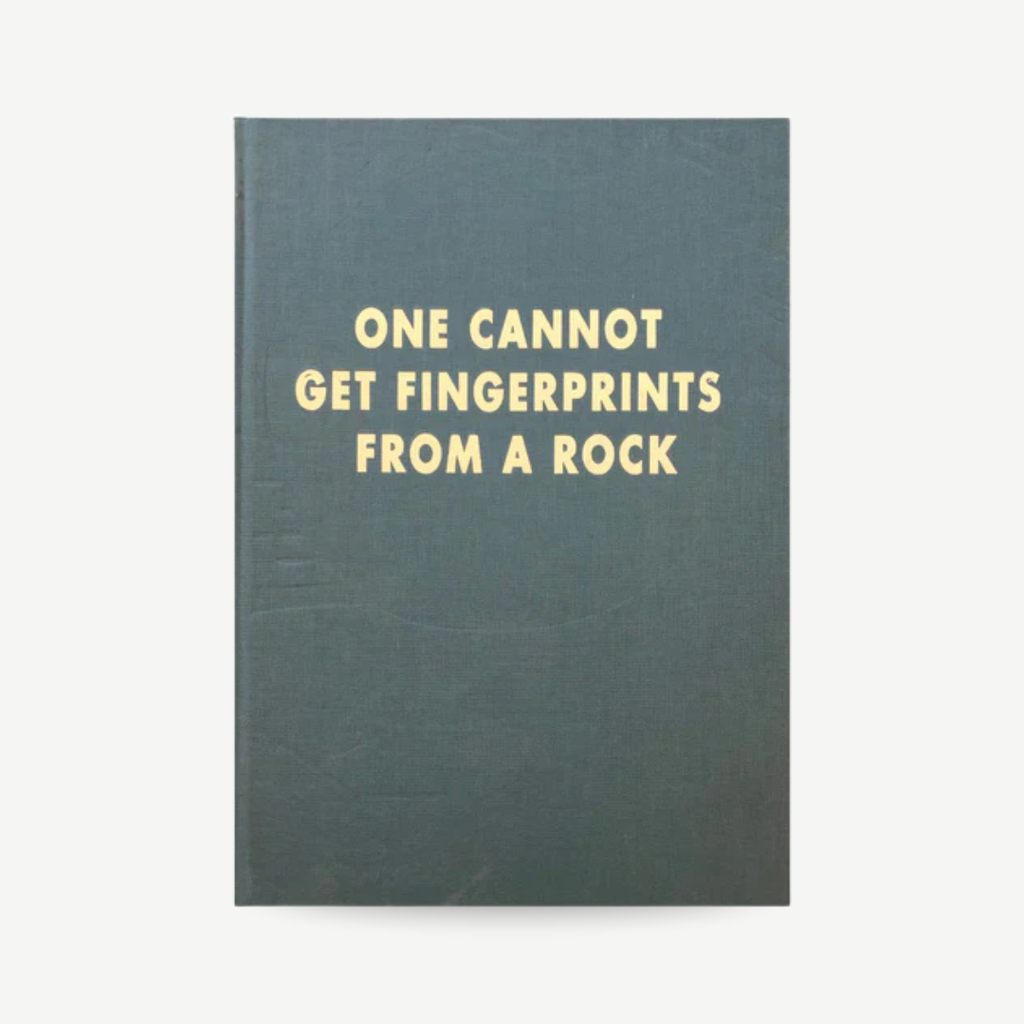Book with text 'ONE CANNOT GET FINGERPRINTS FROM A ROCK' on a white background Barry Reigate - One Cannot Get Fingerprints From A Rock