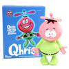 Toy figure of a pink alien with a green outfit next to its packaging