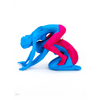 Colorful sculpture of a blue and pink ladies on a white background by Ron English