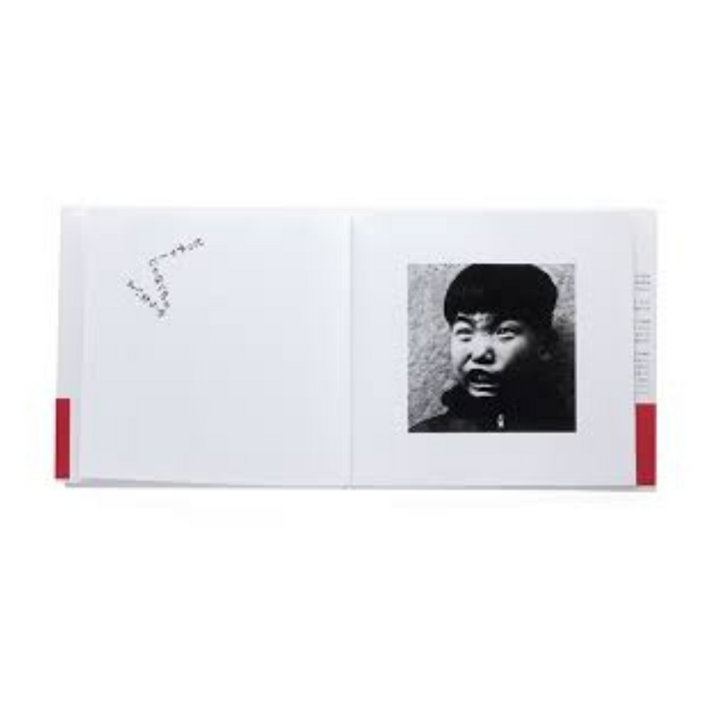 Book with a black and white photo of a person on its cover with photos by Nobuyashi Araki of Japanese children at play.