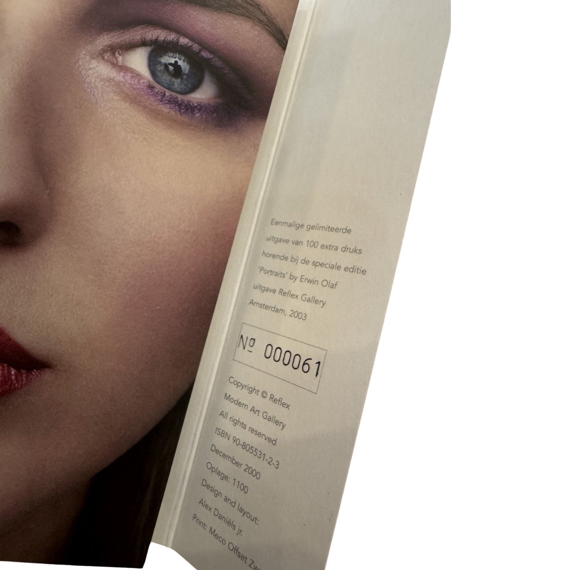 A book cover featuring a close-up portrait of a person with a dark face illuminated by a light source, with the title 'Paradise Portraits' by Erwin Olaf.
