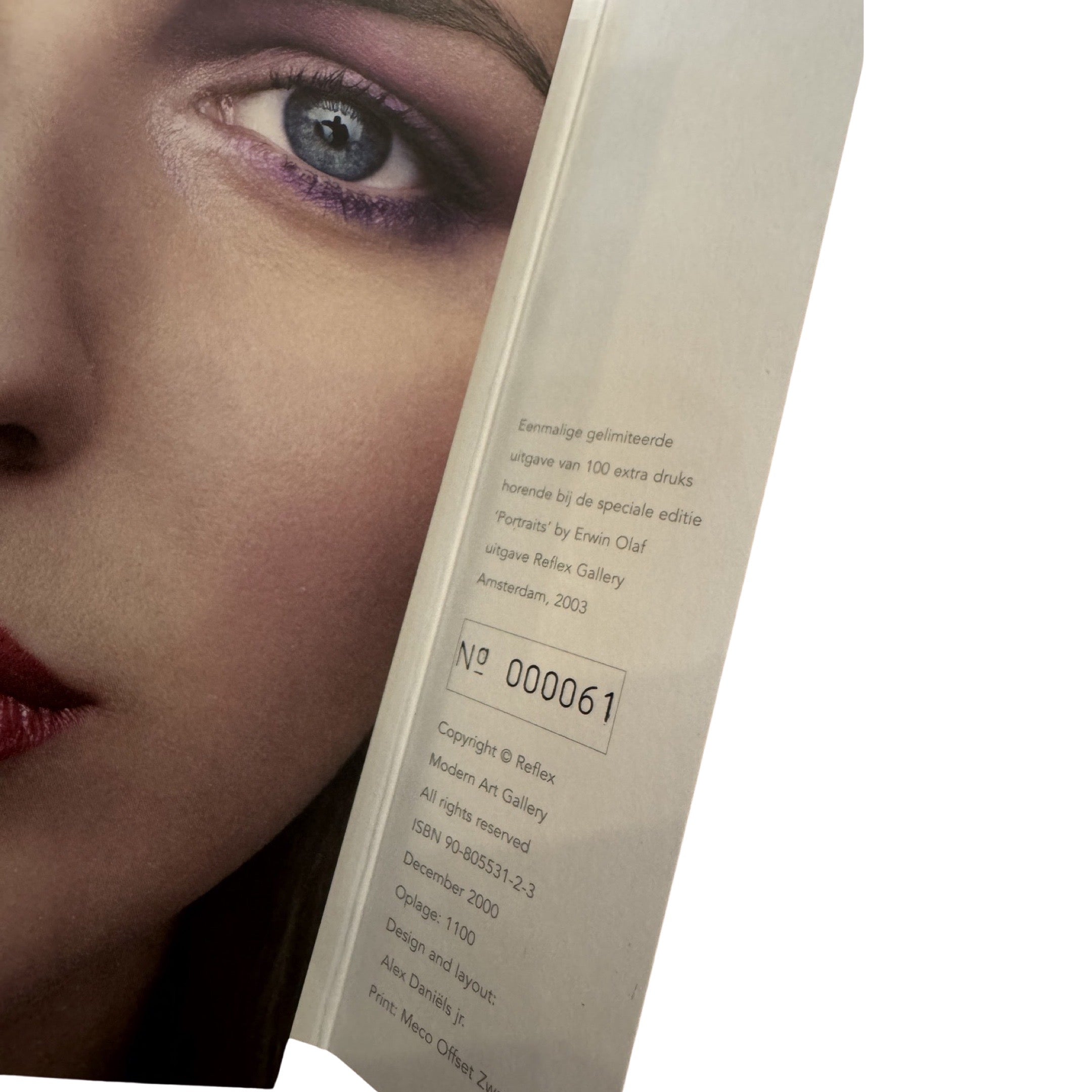 A book cover featuring a close-up portrait of a person with a dark face illuminated by a light source, with the title 'Paradise Portraits' by Erwin Olaf.