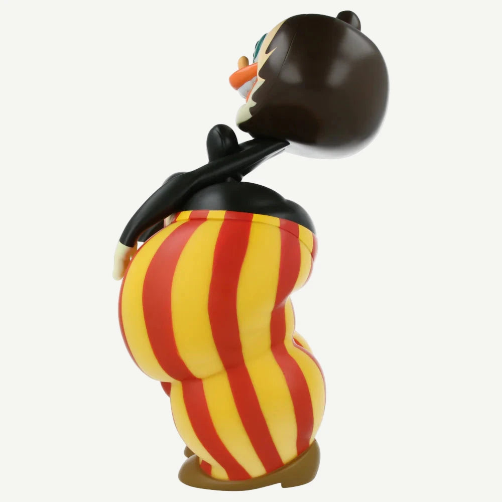 Cartoon character figurine with red and yellow striped pants on a white background