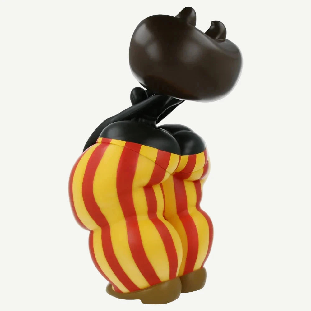 Black cat figurine with red and yellow striped pants on a white background