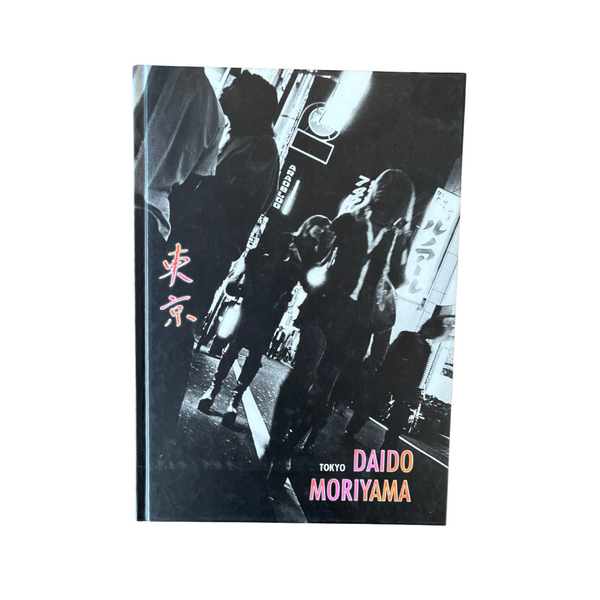 A black and white photograph of a book cover featuring a silhouetted figure in an urban environment, with the title 'Tokyo' and the author's name 'DAIDO MORIYAMA' prominently displayed.